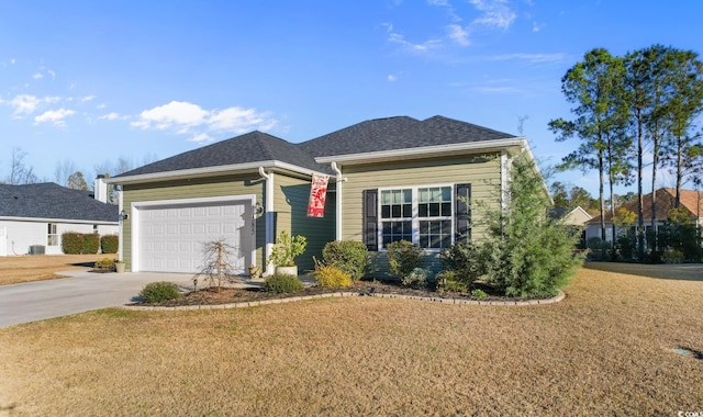 view of front of property featuring a garage, driveway, a shingled roof, and a front yard