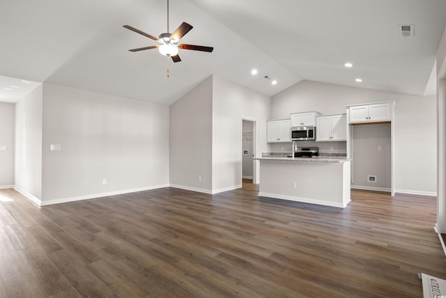 unfurnished living room with baseboards, visible vents, dark wood-type flooring, and a ceiling fan