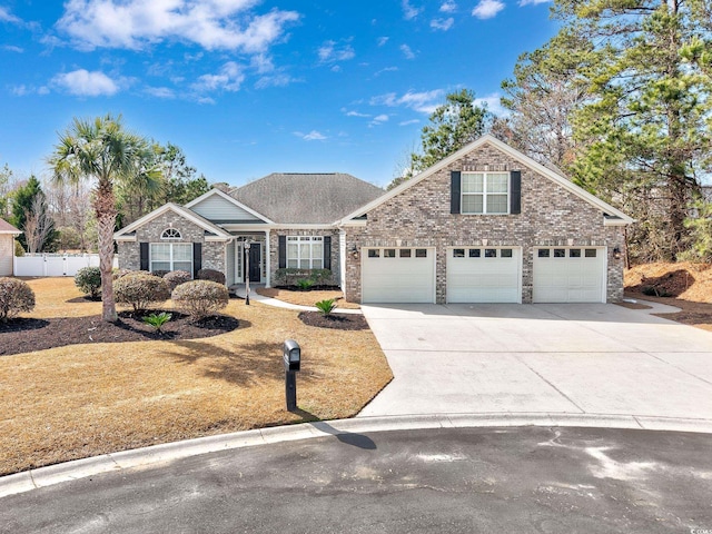 traditional-style house with fence, concrete driveway, and brick siding