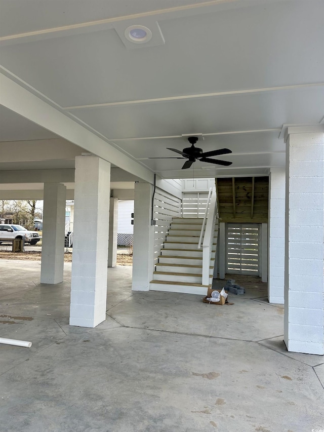 view of patio featuring ceiling fan and stairway