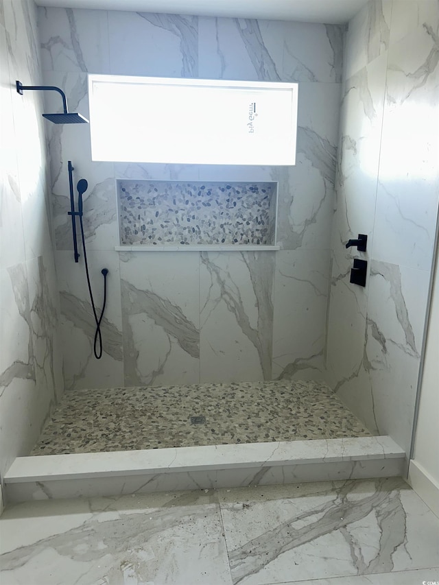 full bathroom with marble finish floor and a marble finish shower