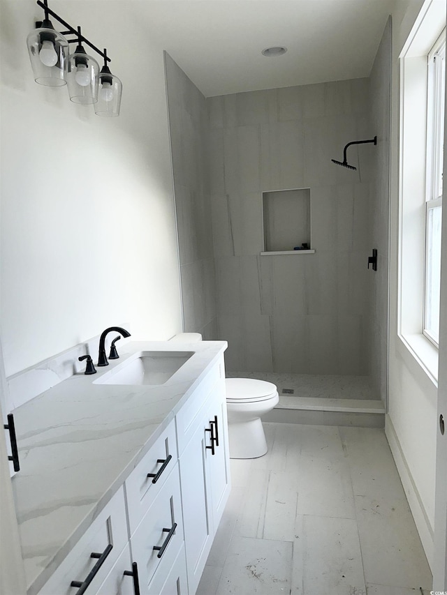 full bath featuring toilet, marble finish floor, a shower stall, and vanity