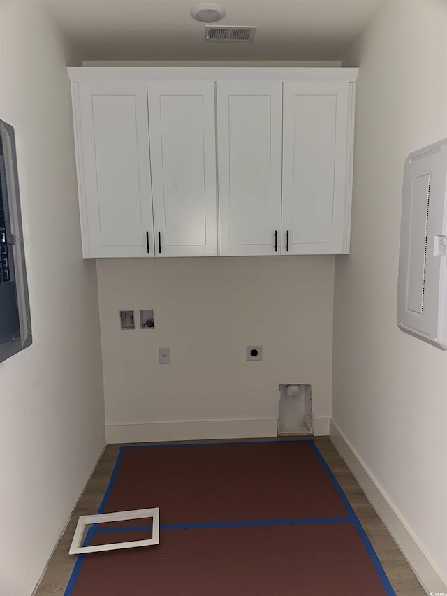 clothes washing area with electric panel, visible vents, dark wood-style floors, hookup for an electric dryer, and washer hookup