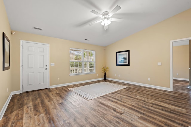 entrance foyer with dark wood finished floors, visible vents, vaulted ceiling, and baseboards