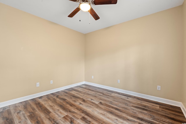 unfurnished room featuring ceiling fan, wood finished floors, and baseboards