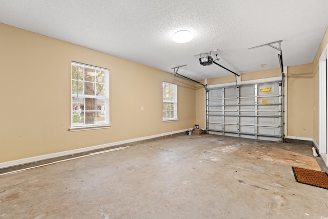 garage featuring a garage door opener and baseboards