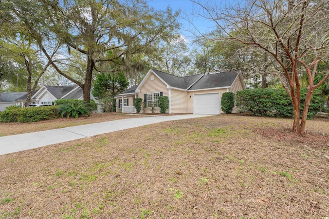 ranch-style home with a front yard, concrete driveway, and an attached garage