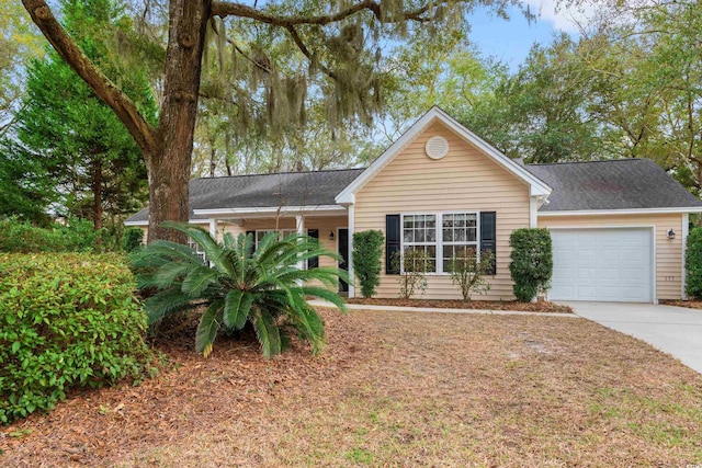 ranch-style home featuring a garage, driveway, and roof with shingles