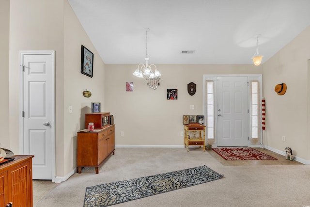 entrance foyer with a chandelier, lofted ceiling, light carpet, and baseboards