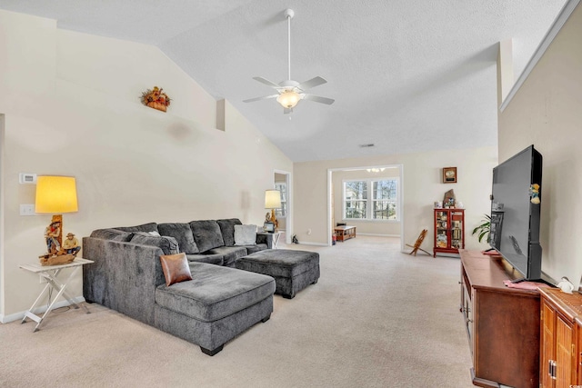 living area with baseboards, light colored carpet, ceiling fan, a textured ceiling, and high vaulted ceiling