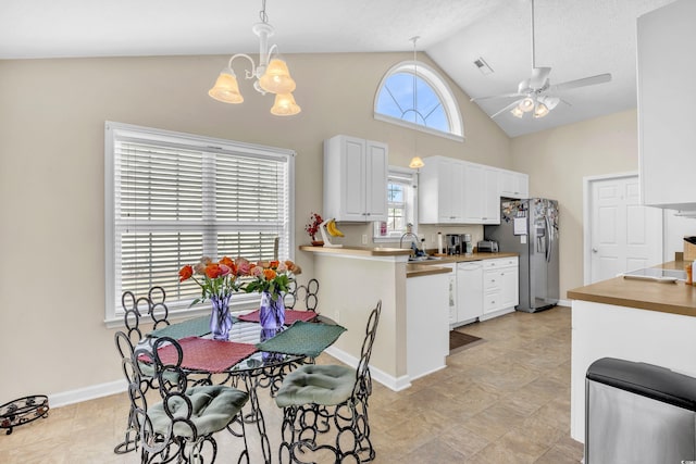 kitchen featuring visible vents, white cabinetry, white dishwasher, stainless steel fridge with ice dispenser, and ceiling fan with notable chandelier