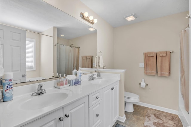 full bath with baseboards, a sink, toilet, and double vanity