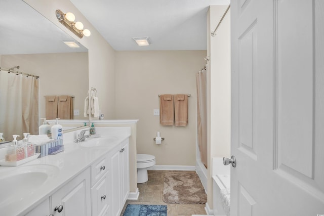 full bathroom with toilet, a shower with curtain, baseboards, and a sink