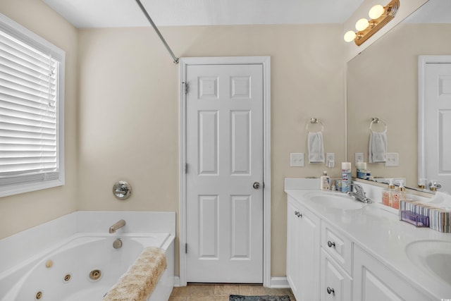 bathroom with a whirlpool tub, double vanity, and a sink