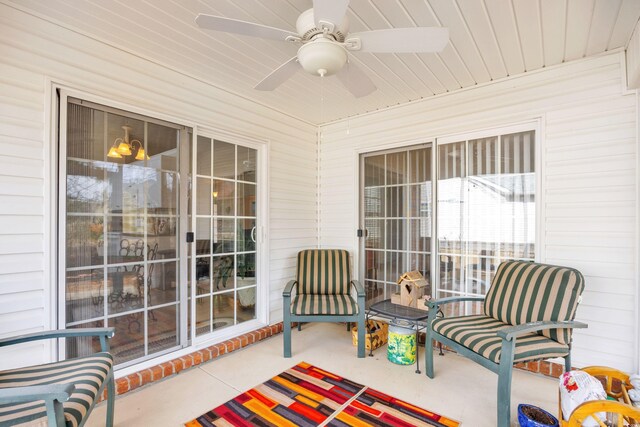 sunroom with wood ceiling and a ceiling fan