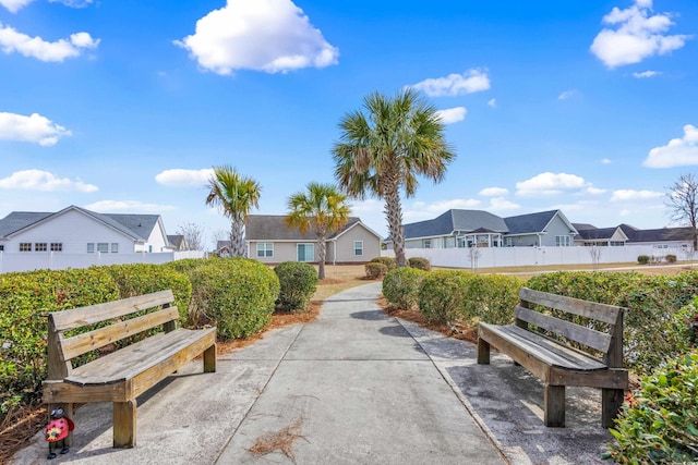 view of property's community featuring a residential view and fence