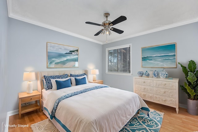 bedroom featuring a ceiling fan, crown molding, baseboards, and wood finished floors