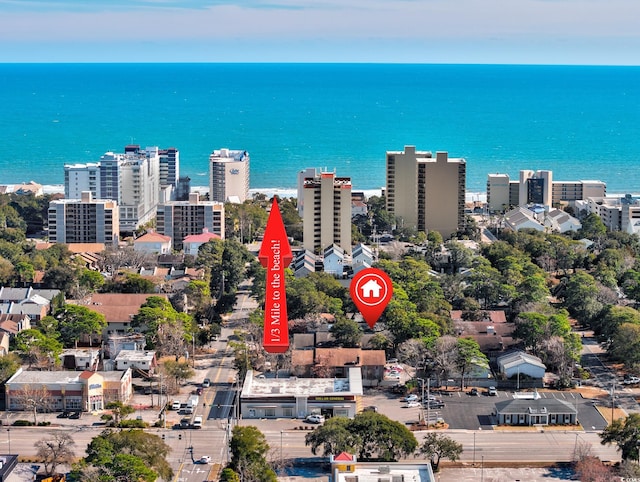 birds eye view of property with a water view and a view of city