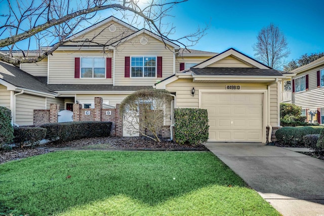 view of front of property featuring a garage, concrete driveway, a shingled roof, and a front yard