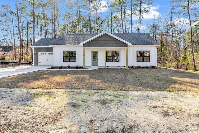 modern farmhouse style home featuring a garage, driveway, and a shingled roof