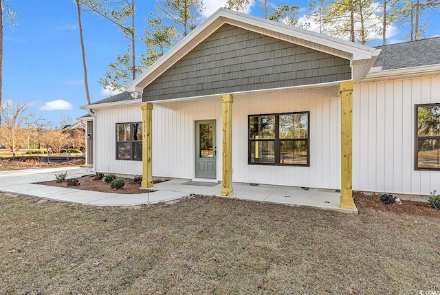 back of property featuring a shingled roof