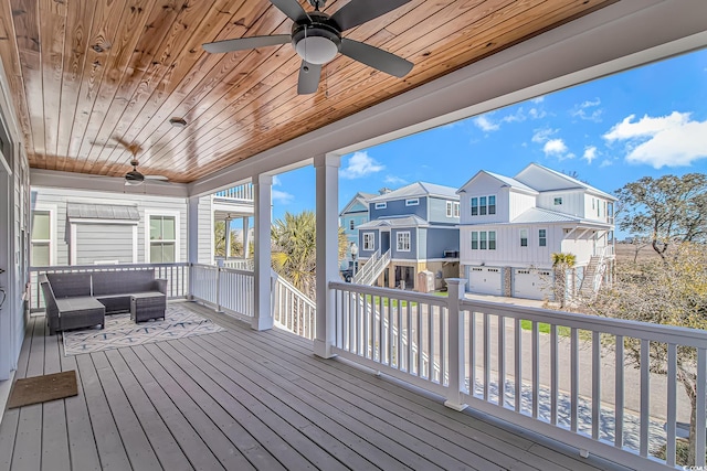 wooden deck featuring ceiling fan, a residential view, and an outdoor hangout area