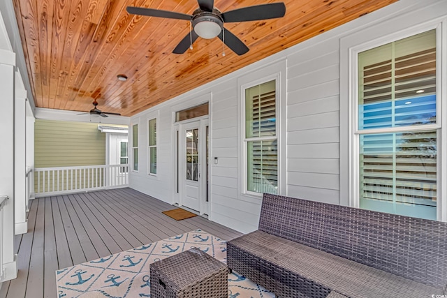 wooden terrace featuring covered porch and ceiling fan