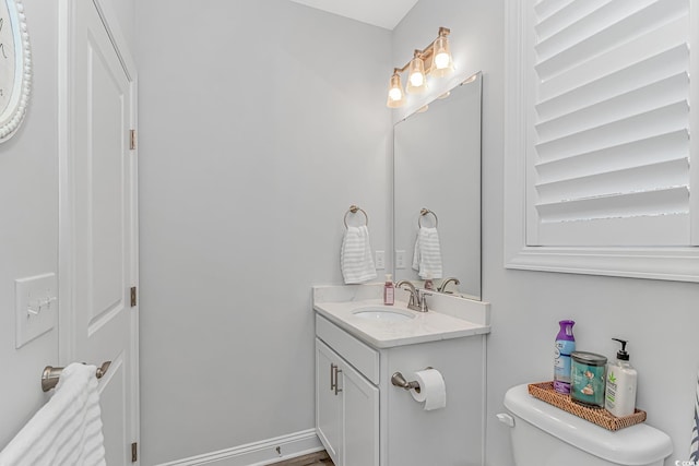 half bath with vanity and toilet