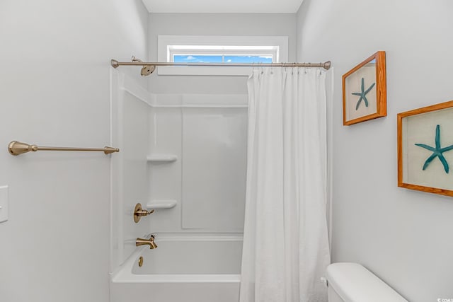 bathroom with shower / bath combination with curtain and toilet