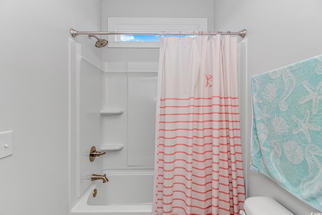 full bathroom featuring toilet and shower / bath combo with shower curtain