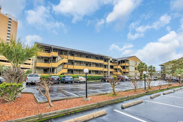 view of building exterior with uncovered parking