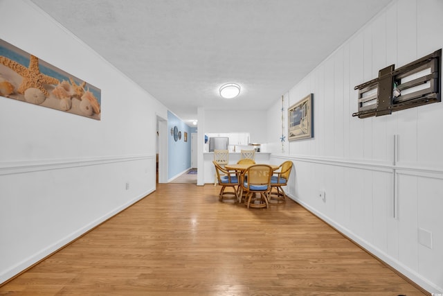 dining room with light wood-style floors and baseboards