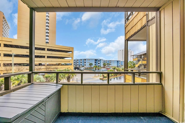 balcony featuring a city view and radiator heating unit