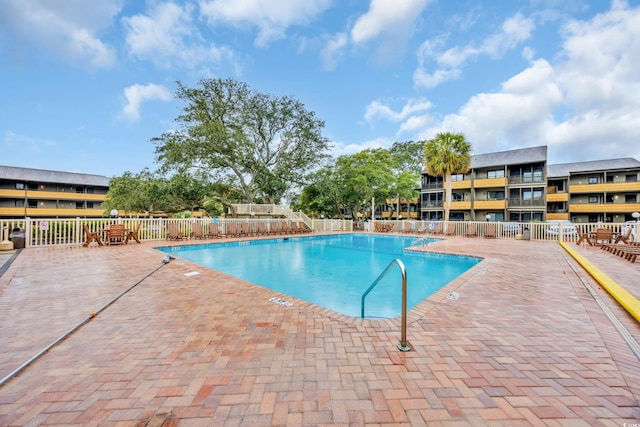 pool featuring a patio area and fence