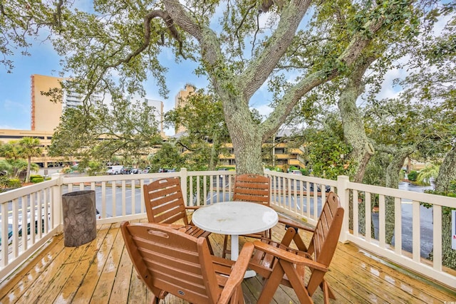 wooden terrace featuring outdoor dining area