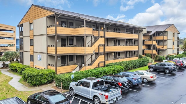 view of building exterior with uncovered parking