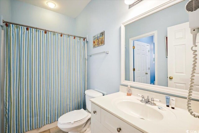 817 S Ocean Blvd Unit 105, North Myrtle Beach, SC 29582 - bathroom with toilet, vanity, and a shower with curtain