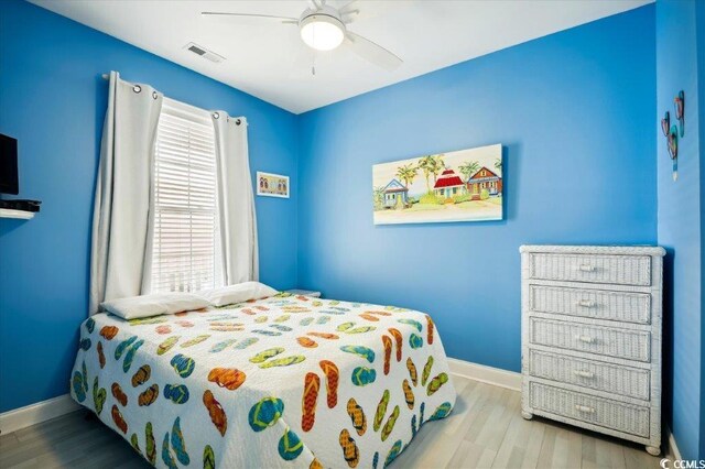 817 S Ocean Blvd Unit 105, North Myrtle Beach, SC 29582 - bedroom with wood finished floors, baseboards, multiple windows, and a ceiling fan