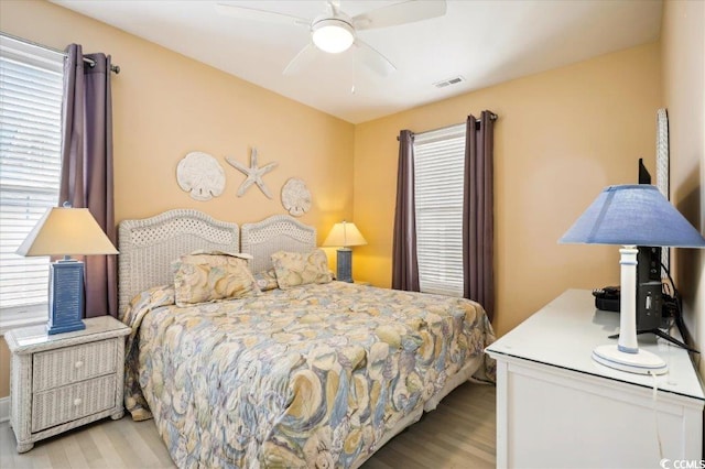 817 S Ocean Blvd Unit 105, North Myrtle Beach, SC 29582 - bedroom with wood finished floors and a ceiling fan