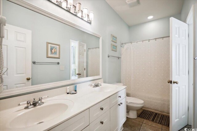 817 S Ocean Blvd Unit 105, North Myrtle Beach, SC 29582 - bathroom with tile patterned floors, toilet, and double vanity