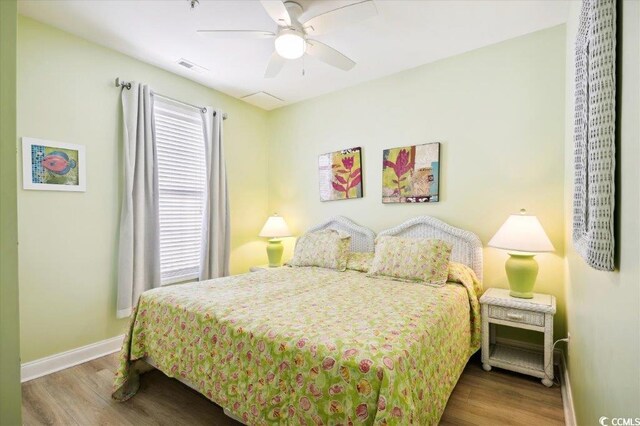 817 S Ocean Blvd Unit 105, North Myrtle Beach, SC 29582 - bedroom with wood finished floors, baseboards, and ceiling fan