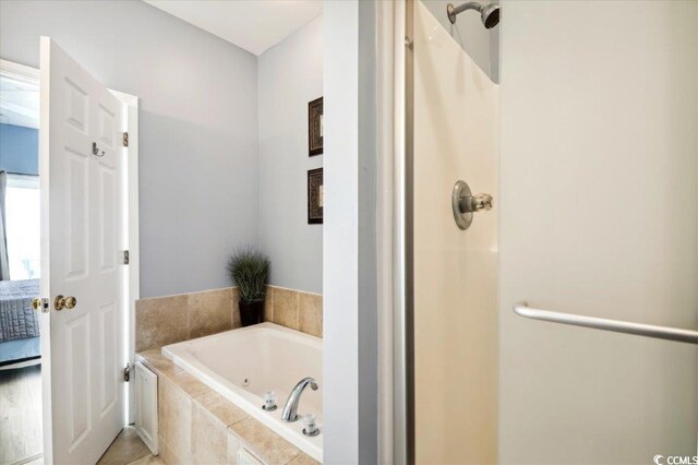 817 S Ocean Blvd Unit 105, North Myrtle Beach, SC 29582 - ensuite bathroom featuring a stall shower and a tub with jets