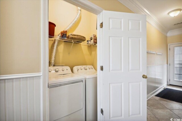 817 S Ocean Blvd Unit 105, North Myrtle Beach, SC 29582 - washroom featuring washer and dryer, crown molding, and tile patterned flooring