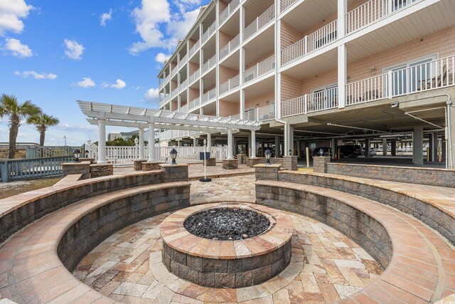 817 S Ocean Blvd Unit 105, North Myrtle Beach, SC 29582 - view of home's community with an outdoor fire pit, a patio area, and a pergola