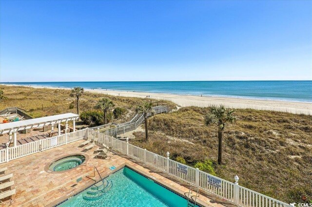 817 S Ocean Blvd Unit 105, North Myrtle Beach, SC 29582 - community pool with a hot tub and view of water and beach
