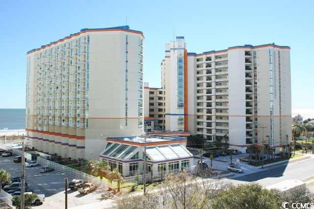 view of building exterior featuring a view of city and a water view