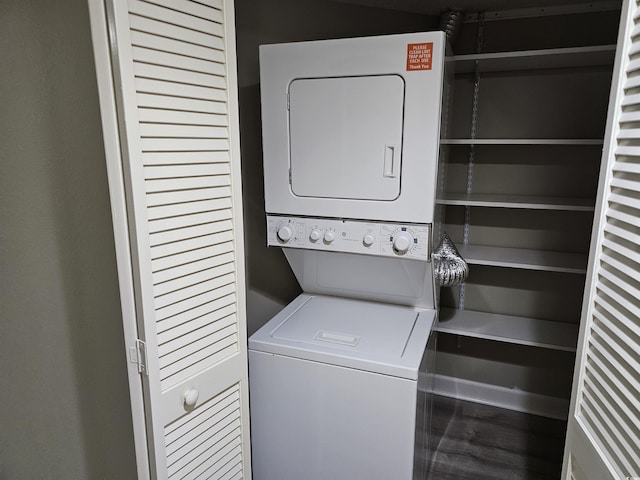 laundry area featuring stacked washer and dryer and laundry area