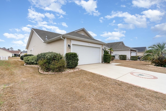 view of front of property with a garage, concrete driveway, and a front yard