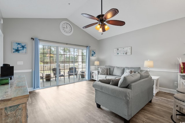 living room featuring lofted ceiling, ceiling fan, baseboards, and wood finished floors