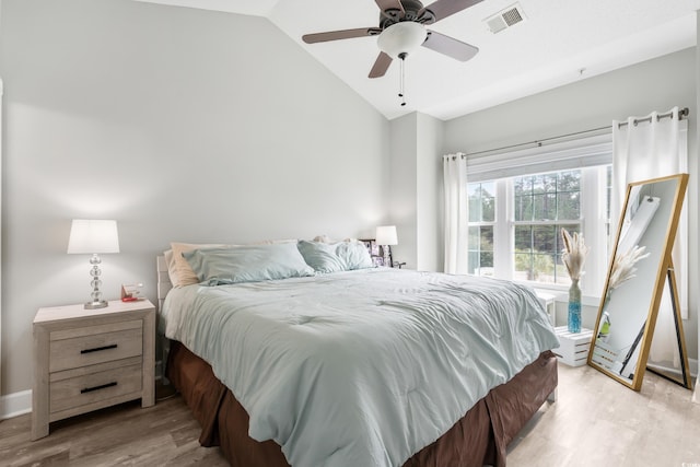 bedroom with lofted ceiling, light wood-type flooring, visible vents, and a ceiling fan